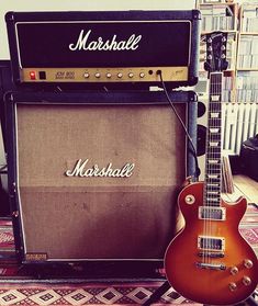 a guitar and amp sitting on top of a rug