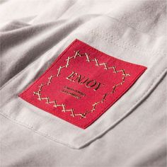 a red label is on the pocket of a white shirt that says, joma