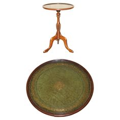 an antique wooden table with a green tray on it's legs and a white background