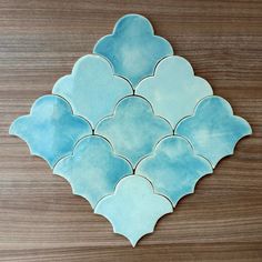 a blue and white tile design on a wooden surface