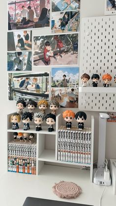 a white desk topped with lots of anime figurines