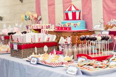 a table topped with lots of cakes and desserts