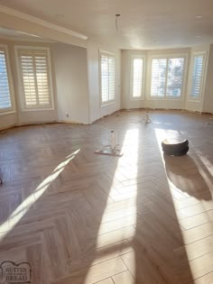 an empty room with hard wood floors and shutters on the windows is being renovated