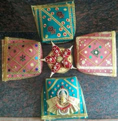 four pieces of cloth with designs on them sitting next to each other in a circle