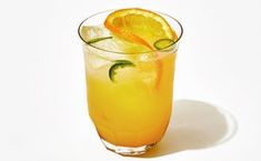 a glass filled with orange juice and garnished with an orange slice on the rim