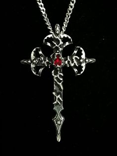 This Gothic Cross necklace is an handmade pewter sculpture orned with a swarovski of your choice. This cross is made thick and solid, the stainless steel chain is very solid, this necklace is alright to wear during Live Action Role Playing games (LARP) or music shows.   This Gothic Cross Pendant is sold with a stainless steel chain This Gothic Cross is a pendant of 6.5cm  This Gothic Cross Necklace is a pewter sculpture of my own creation, i create and work the metal by myself at home. The material used is the finest and highest grade hypoallergenic pewter alloy of 98%tin You can combine many of my creations in an order to save on shipping charges, it is always same price no matter how many items you order  Wholesale is available for stores, if you are interested please contact me about th Gothic Cross Necklace, Art Folio, Pentagram Necklace, Gothic Cross, Gothic Crosses, Elegant Gothic, Role Playing Games, About Me Questions, Crystal Stars