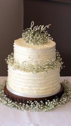 a wedding cake with the word love on top