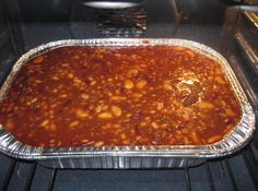 a pan filled with chili and beans cooking in an oven