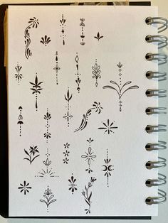 an open notebook with various designs on it