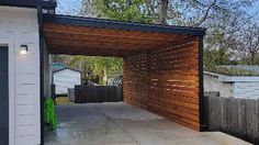 an outdoor garage with a wooden roof