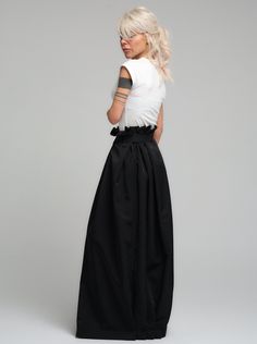 Make a bold statement with our high-waist skirt, the epitome of tailored elegance. This skirt is fashioned from premium polyester, delivering a smooth finish with a substantial feel that gracefully flows with every step. The design is accentuated by a tasteful belt that cinches the waist, while the elasticated back ensures a snug and comfortable fit. Its voluminous silhouette and sleek lines make it a versatile piece for both office wear and evening affairs. FEATURES:Includes a chic belt, elasticated back for comfort, and a high-waist cut 100% Handmade. SIZE & FIT: Fit: A relaxed fit with room to moveModel is wearing size Small or S/M View our SIZE CHART before ordering MATERIALS & CARE: Content: Polyester Care: Dry cleaning only SHIPPING: Made to order, processing time is 15 working days Chic Fitted Skirt With Wide Waistband, Elegant Satin Pleated Skirt For Spring, Chic Flared Skirt With Wide Waistband, Chic Flared Cocktail Skirt, Chic Satin Pleated Skirt, Chic Satin Flowy Pleated Skirt, Summer Evening Bottoms With Pleated Waist, Chic Cocktail Flared Skirt, Chic Spring Skirt With Wide Waistband