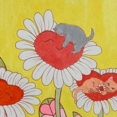 an image of two cats sleeping on the flowers with one cat laying on the flower