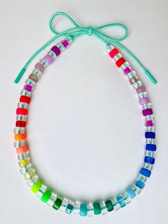 multicolored glass beaded necklace on white background