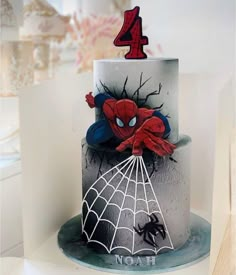 a spiderman birthday cake with the number four on top