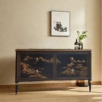 a black and gold painted cabinet in a living room with a painting on the wall