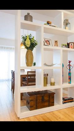 a living room filled with lots of white shelves