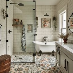 a bath room with a tub a sink and a mirror on the wall next to a window