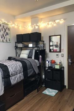 a bed room with a neatly made bed next to a dresser and mirror on the wall