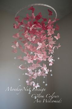 pink butterflies hanging from the ceiling in a room