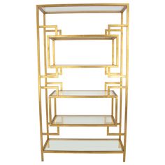 a gold shelf with glass shelves on it