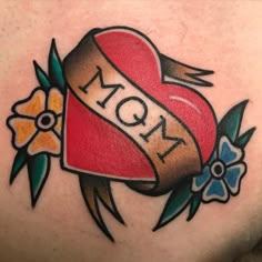 a woman's stomach with a tattoo on it that reads mom and has flowers around the waist