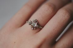 a woman's hand with a diamond ring on it