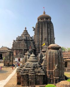 an elaborately carved temple in india with people walking around it and other buildings on either side