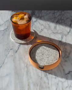 a drink in a glass on a marble table