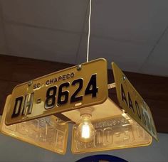 two yellow street signs hanging from the ceiling above a blue sign that says route 662