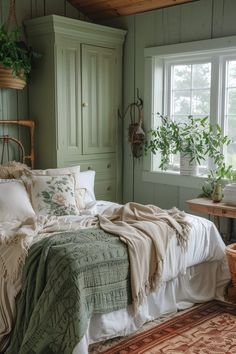 a bed sitting next to a window in a room with lots of plants on the wall