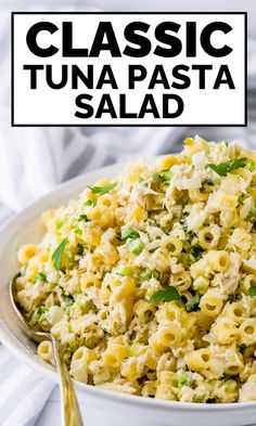 a white bowl filled with pasta salad on top of a table