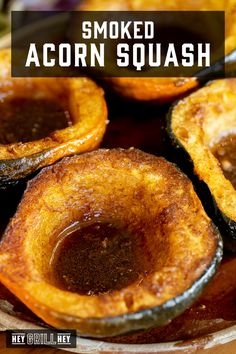 baked acorn squash on a plate with the words smoked acorn squash above it