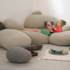 a woman laying on top of a couch covered in rocks