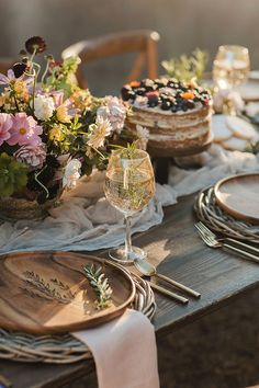 the table is set with flowers and desserts