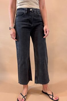 Get ready to rock the edgy chic look with these Black Crop Wide Leg Jeans. With a 23 1/2 inch seam, raw hem, slight (very slight) stretch, and distressed details, they exude effortless coolness. The lightweight denim is tapered in the back for the perfect fit, while maintaining the relaxed wide leg style. Dare to be different! Fit is true to size, Amber is modeling size small. She is 5’6”. Imported Cotton blend. Everyday Stretch Distressed Bottoms, Stretch Distressed Bottoms For Everyday, Distressed Stretch Bottoms For Everyday, Edgy Dark Wash Flare Jeans With Frayed Hem, Dark Wash Stretch Cropped Jeans With Frayed Hem, Trendy Distressed Bottoms For Everyday, Stretch Cropped Jeans With Frayed Hem In Dark Wash, Everyday Distressed Cropped Bottoms, Everyday Distressed Cropped Leg Bottoms