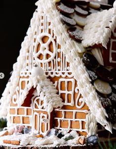 a gingerbread house with white icing and decorations