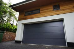 a garage door is open in front of a house