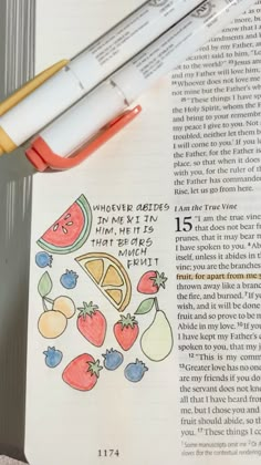 an open book with some fruit on it and a marker pen next to the page