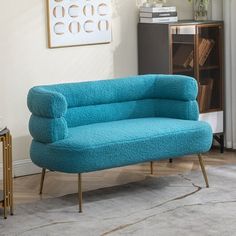 a blue couch sitting on top of a rug in a living room