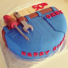 a birthday cake that is shaped like a tool belt and wrench with the words happy birthday on it