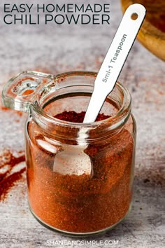 an easy homemade chili powder recipe in a jar with a spoon sticking out of it