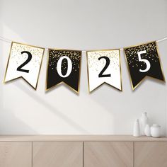 a black and gold new year banner hanging on a wall next to a dresser with vases