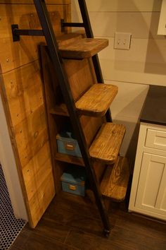 a set of wooden steps leading up to a kitchen counter top with drawers below it