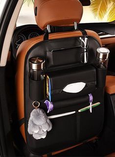 the back seat of a car with an umbrella and cup holder in it's pocket