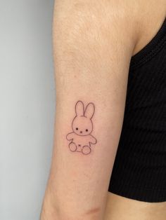 a small bunny tattoo on the arm