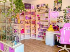 a room filled with lots of toys and shelves next to a desk in front of a window