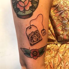 a woman's leg with tattoos on it and an image of a jar of honey