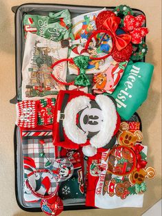 an open suitcase filled with assorted christmas items