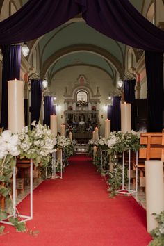 the aisle is decorated with candles and flowers