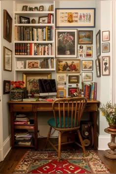 a home office with lots of books and pictures on the wall